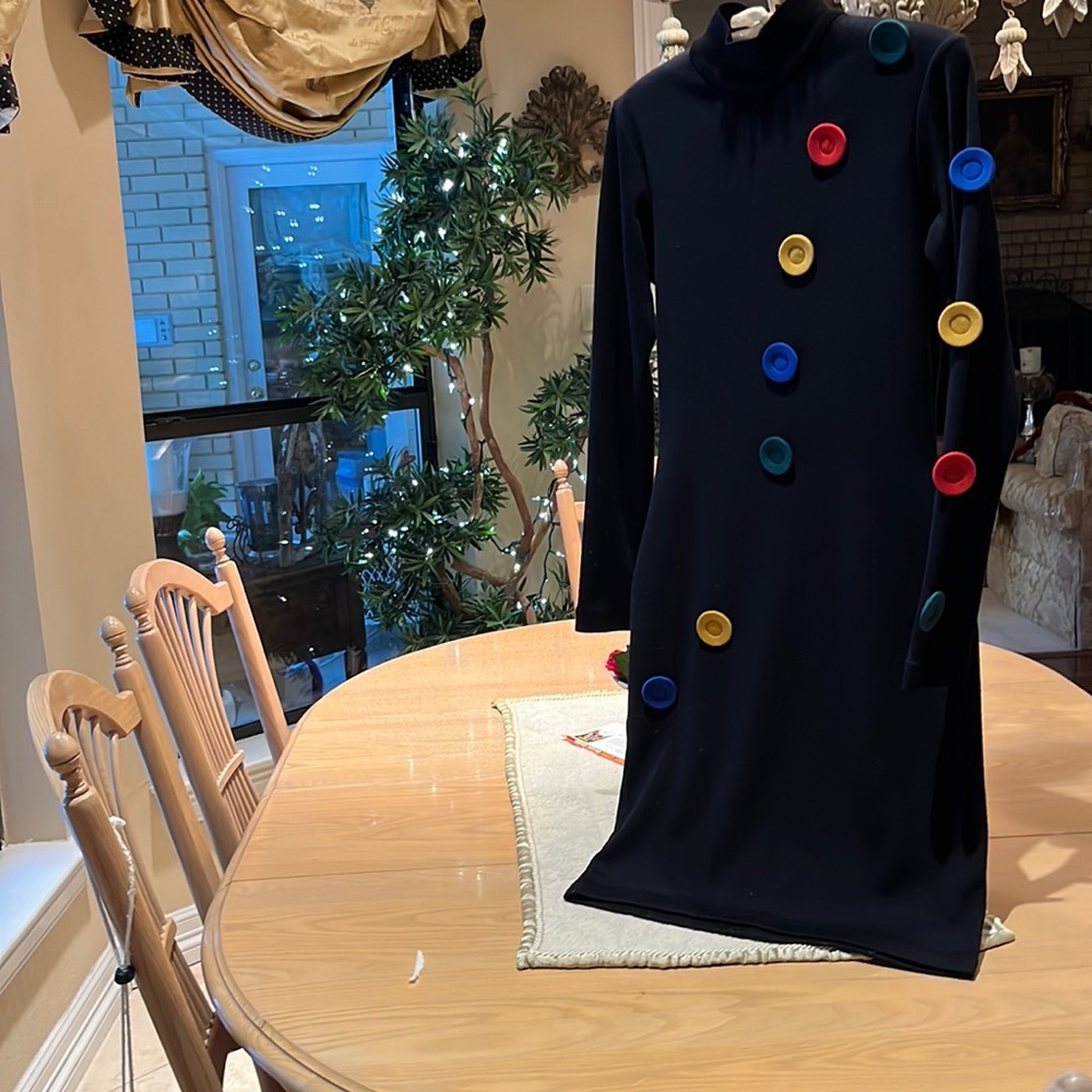 Fun black dress with colorful button that will get you noticed!